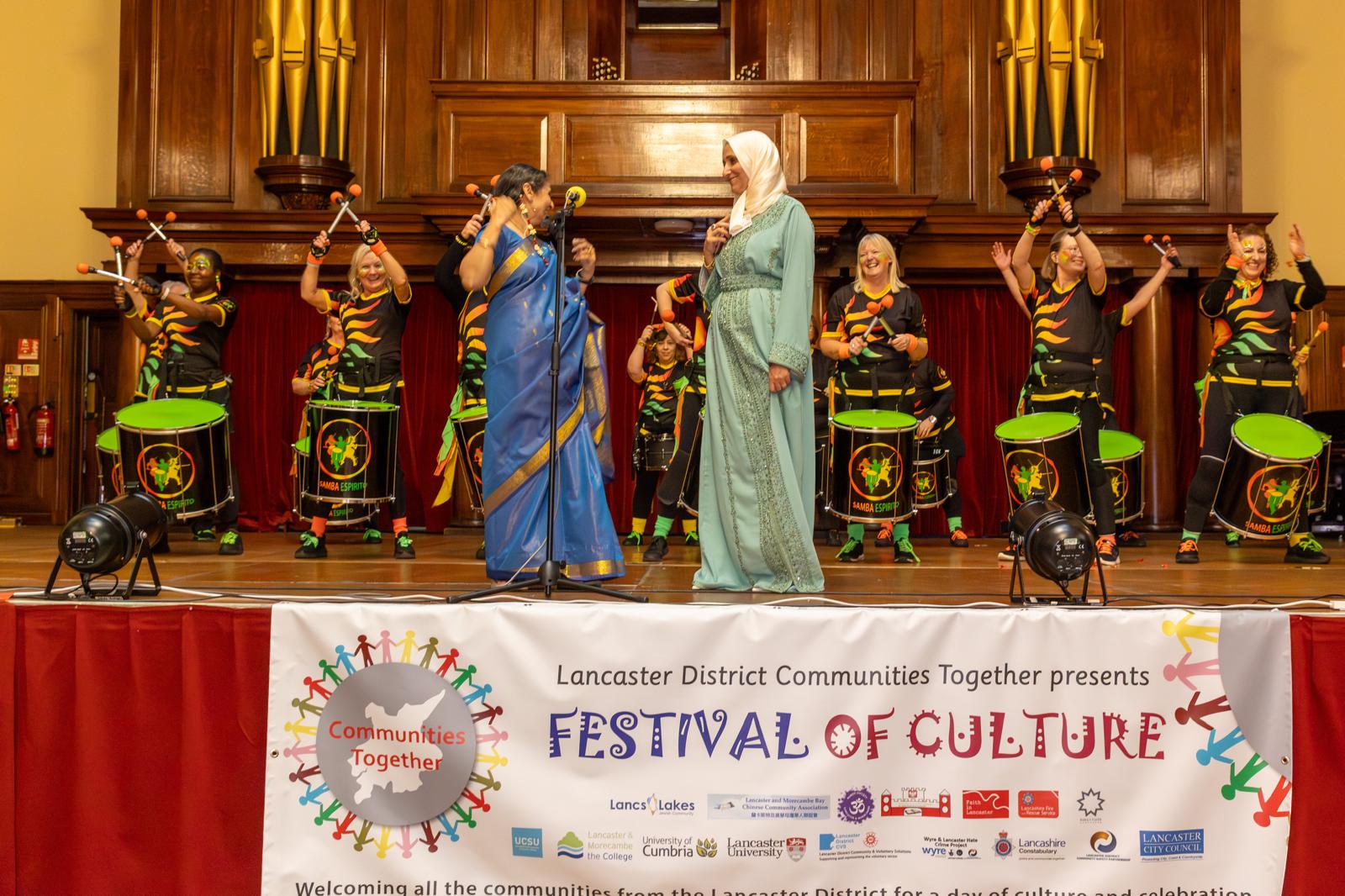 Samba drummers on stage with Harsha at the Festival of Culture