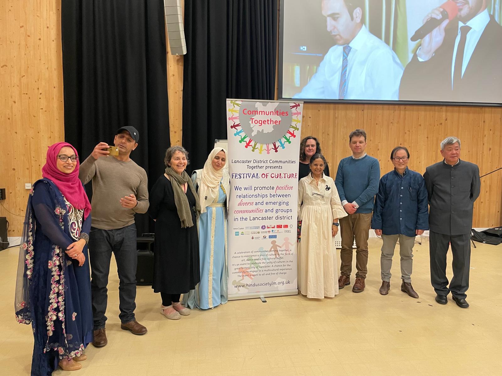 Harsha with organisers in front of the Festival of Culture banner