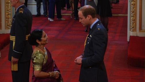 Harsha receiving her MBE from Prince William at Buckingham Palace